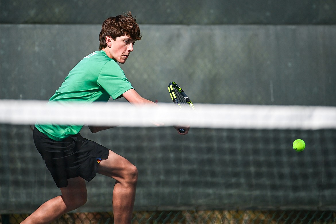 Glacier's Carl Bitney hits a backhand return in a boys singles match against Flathead's Ezias Bailey at Flathead Valley Community College on Thursday, April 11. (Casey Kreider/Daily Inter Lake)