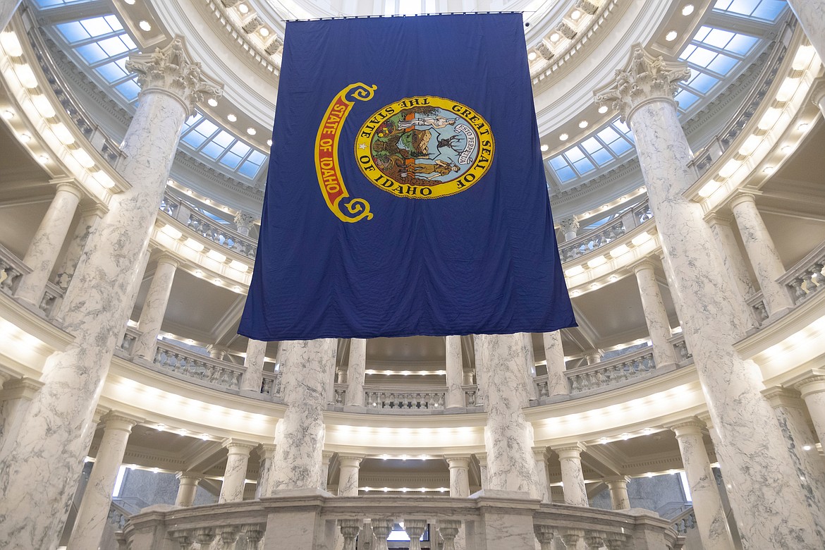 The Idaho state flag hangs in the State Capitol in Boise, Idaho, Jan. 9, 2023. Idaho lawmakers spent much of an unexpectedly long and sometimes contentious legislative session focusing on bills targeting LGBTQ+ residents by limiting health care and reading materials. They also passed a bill that allows the state to spend $2 billion over the next decade to address dilapidated public school buildings and other school facility needs. (AP Photo/Kyle Green, File)