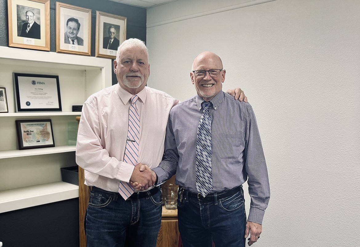 Newly appointed Kellogg Mayor Rod Plank (right) shakes hands with Councilman Terry Douglas following Plank's swearing-in ceremony at the city's April council meeting. Plank is replacing longtime mayor Mac Pooler, who resigned due to health concerns last month.