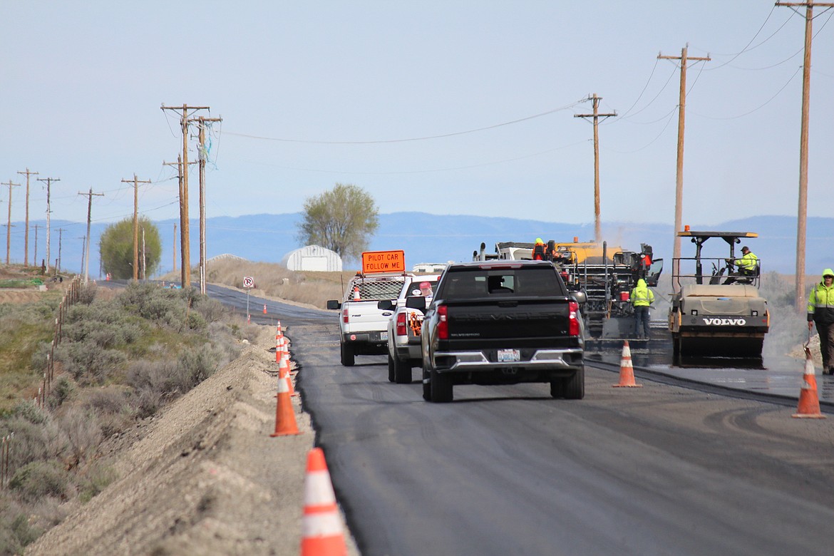 A pilot car leads traffic through the construction zone on Silica Road Southwest last week. The Silica Road project, designed to improve traffic flow around the Gorge Amphitheatre, should be substantially completed by the end of April.
