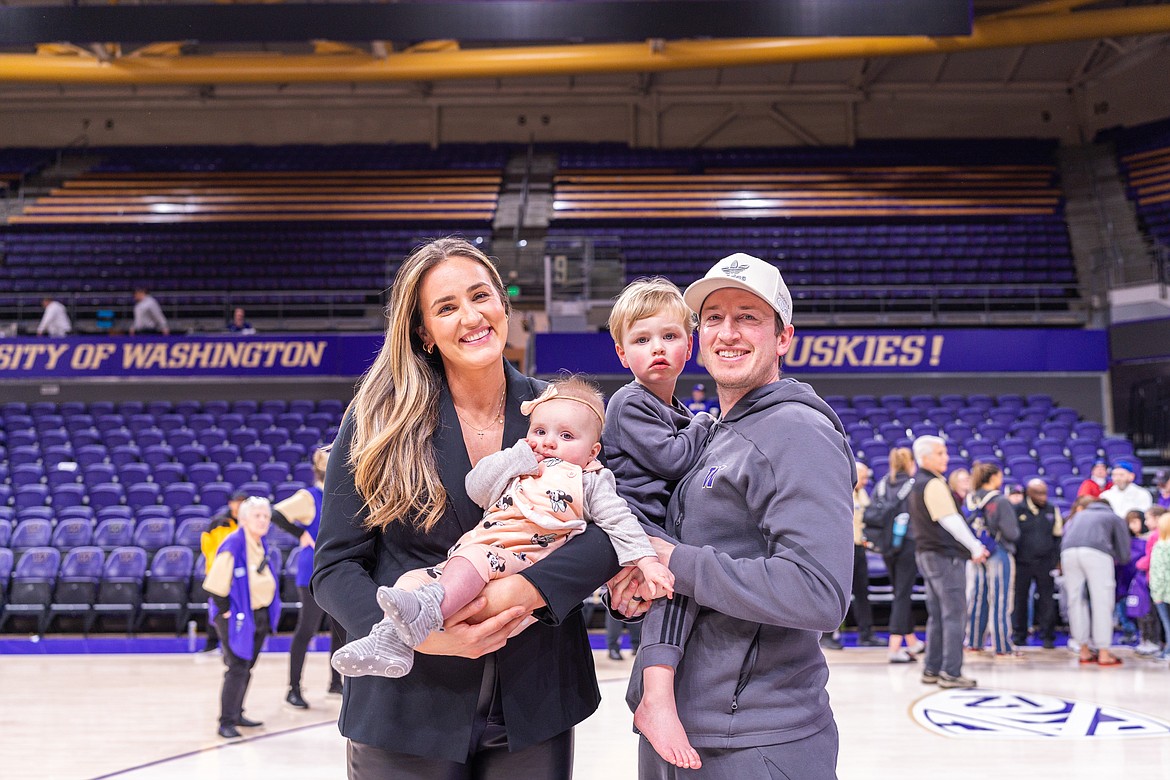 Courtesy University of Washington Athletics
Katie (Baker) Faulkner, left, holding Laney, and husband Derek Faulkner, holding Baker.