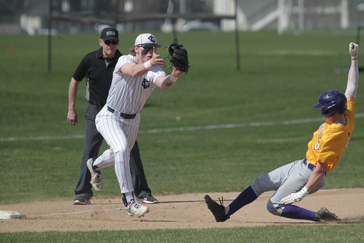 MARK NELKE/Press
Lake City third baseman Travis Usdrowski tries to tag out Tucker Green of Lewiston in the second game Saturday at Lake City.