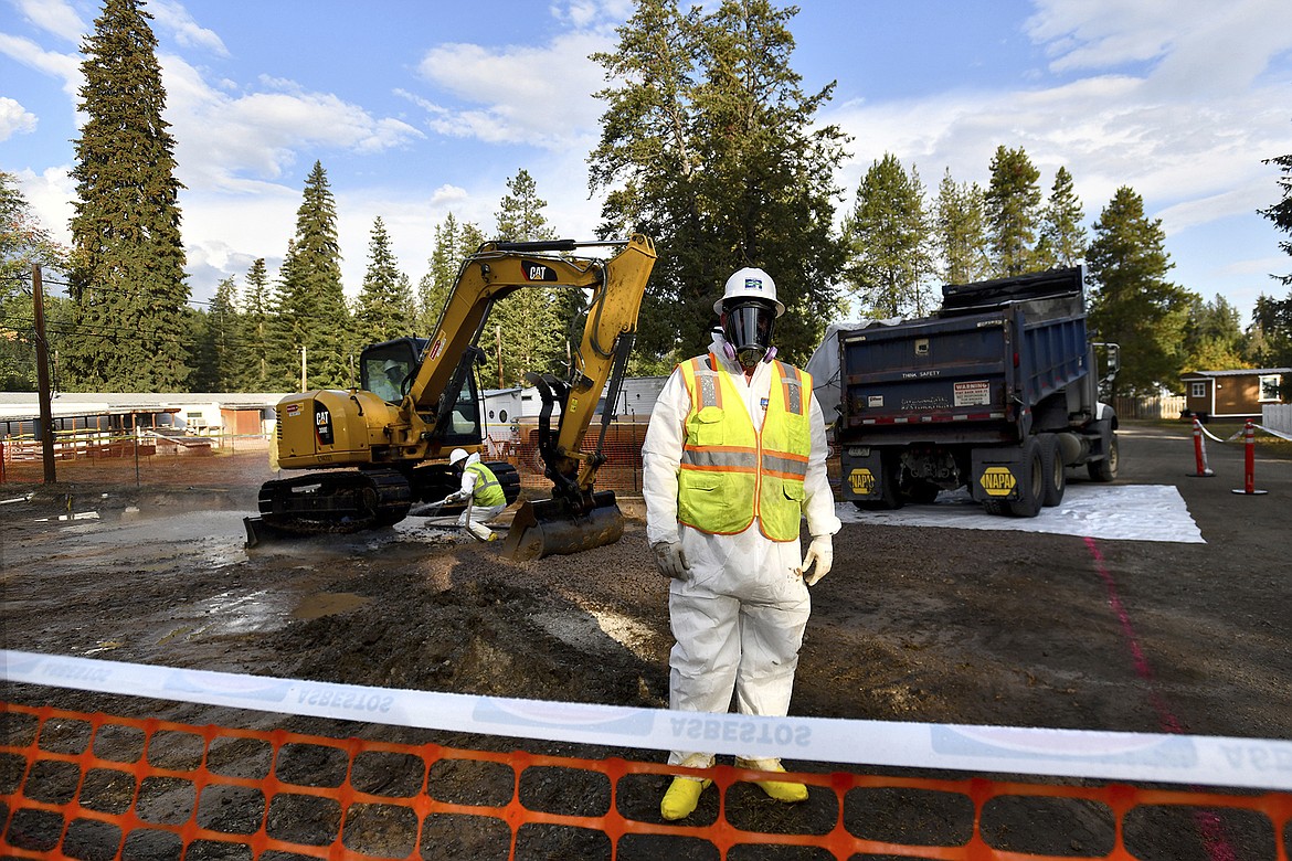 Environmental cleanup specialists work at an asbestos cleanup site in Libby, Montana, on Sept. 13, 2018. A lawsuit being tried in federal court alleges BNSF Railway knew the vermiculite it was hauling through Libby from a nearby mine was tainted with asbestos. The railroad denies the allegations. (Kurt Wilson/The Missoulian via AP, File)