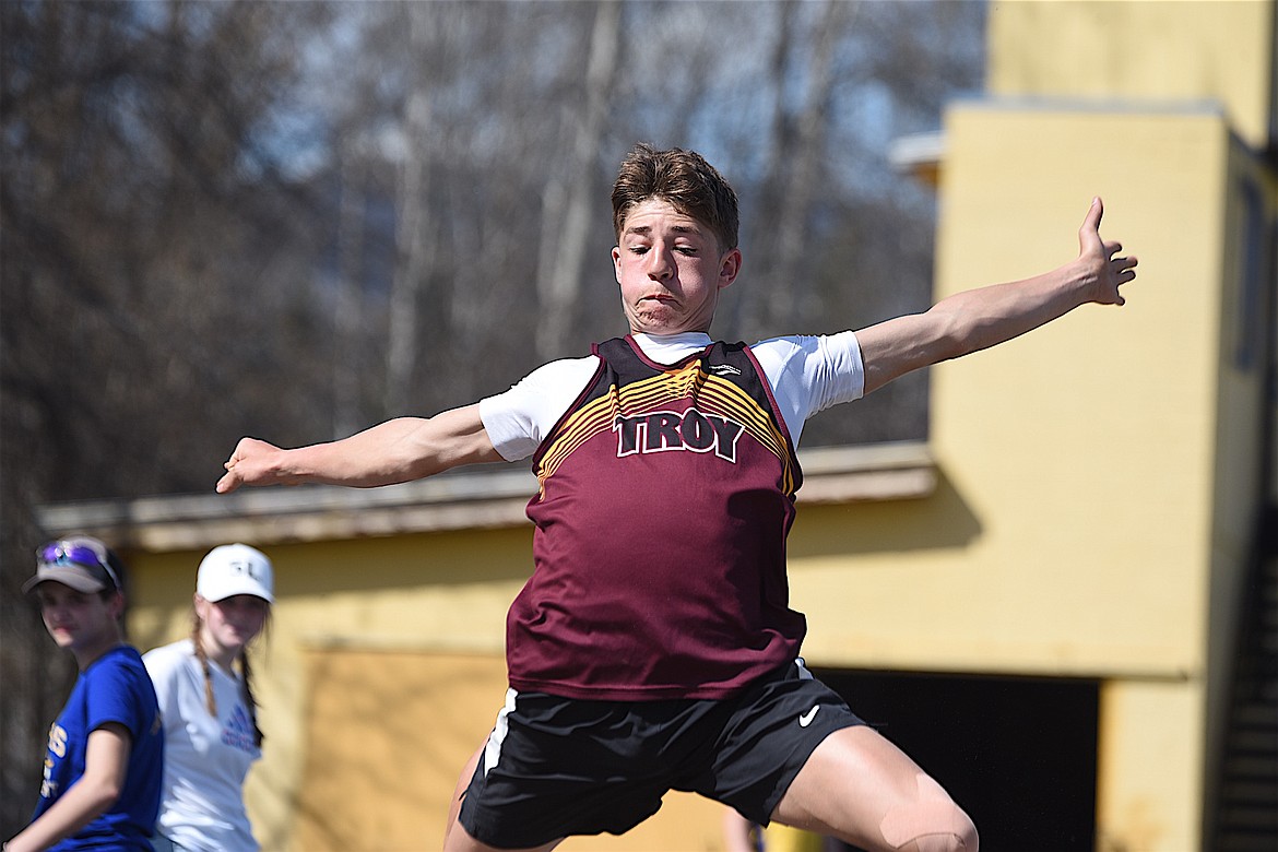 Troy's Carson Orr triple jumps on Saturday, April 13, 2024 at the Libby Track and Field Invitational. (Scott Shindledecker/The Western News)