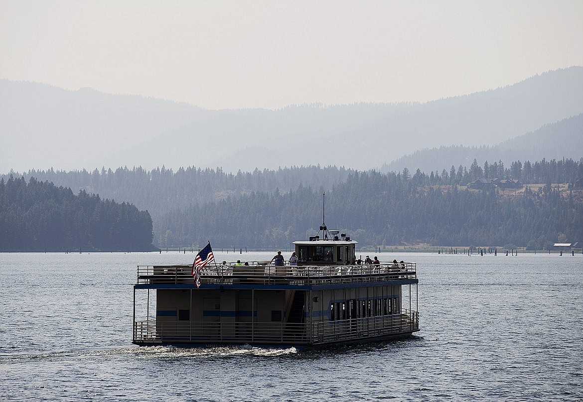 A Coeur d’Alene Resort Cruise boat floats on Lake Coeur d’Alene under a smoke-filled sky, Aug. 2, 2017.