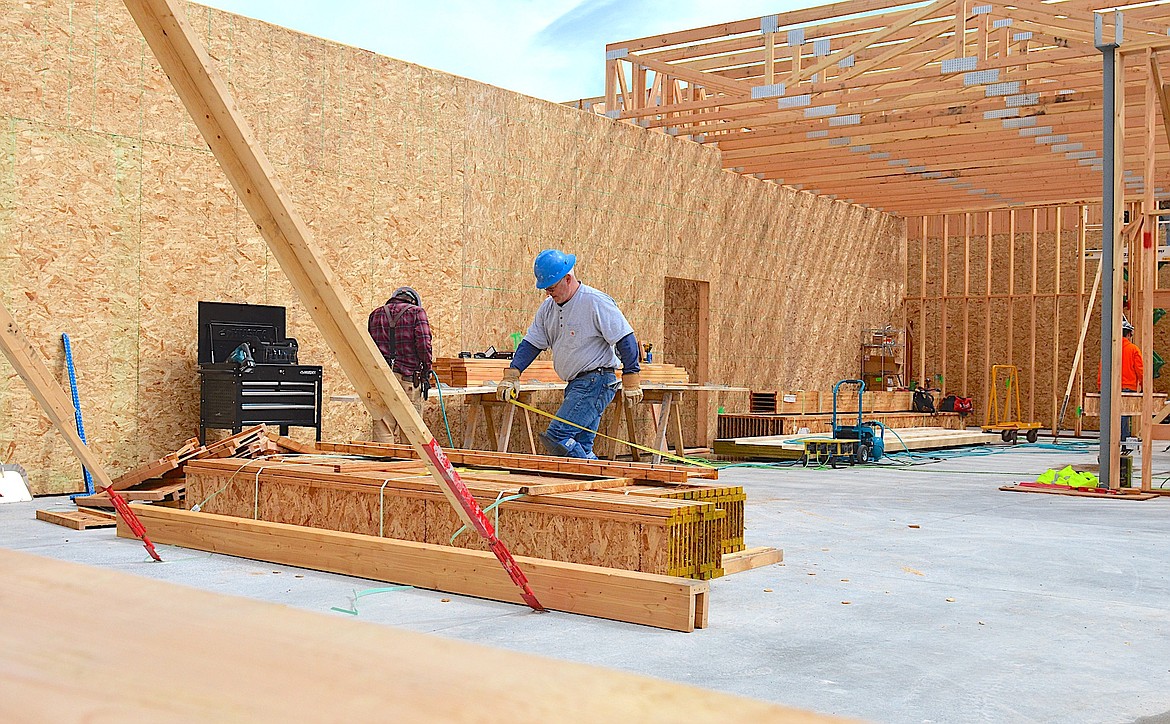 FRAMER BRIAN CULLEN takes a measurement at Cherry Valley Elementary School Monday, where Swank Enterprises is building an addition. Cullen was at work in the future library, which will tentatively be finished in time for school to start next fall. (Kristi Niemeyer/Leader)