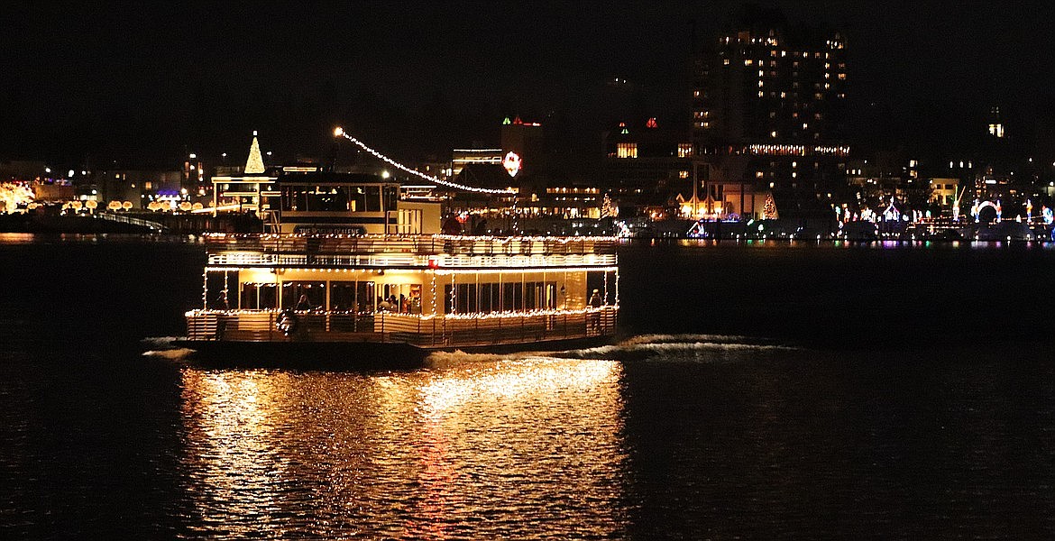 A member of the Lake Coeur d'Alene Cruises fleet glows in the dark as it heads across Lake Coeur d'Alene on its Journey to the North Pole.