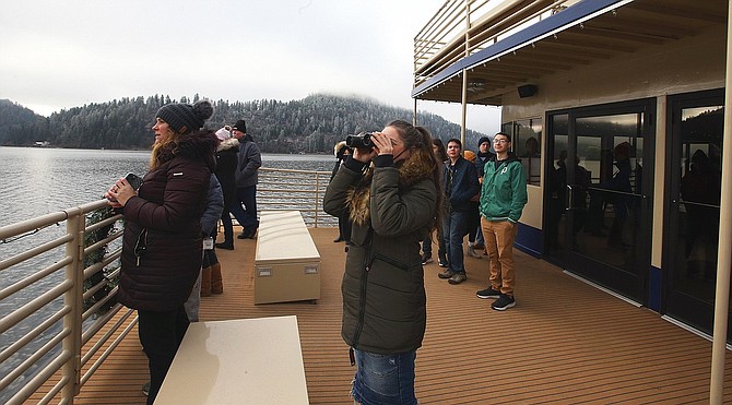 People takes pictures and watch bald eagles from a Lake Coeur d'Alene Cruises boat at Wolf Lodge Bay.