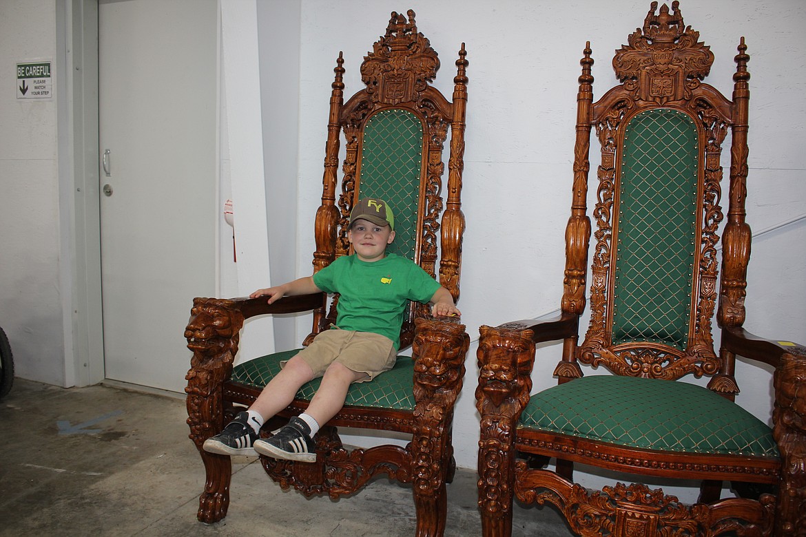 "King Crabb" as his family calls him was begging his mother, Stacey, to bid on at least one chair. The Crabb Family lives up Sunrise Creek just a few miles from the auction. (Monte Turner/Mineral Independent)