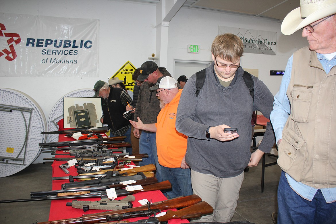 Three tables had shotguns, rifles and pistols that drew attention along with assorted ammunition and knives. (Monte Turner/Mineral Independent)