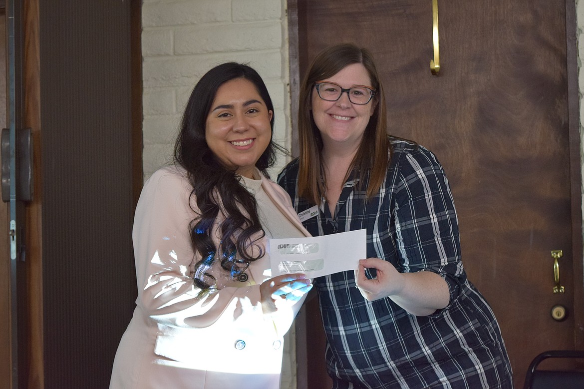 Greater Othello Chamber of Commerce Manager Jackie Wilhelm, left, accepts a grant award from Rural Development Initiatives Leadership Services Business Manager Christine Gilmore as part of the Rural Community Leadership Program.