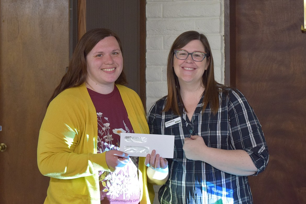 RDI’s Christine Gilmore, right, who led the Rural Community Leadership Program in Othello, presents a grant to Old Hotel Art Gallery Director Samantha Copas, left, who said the funds would be used to hold more art classes.