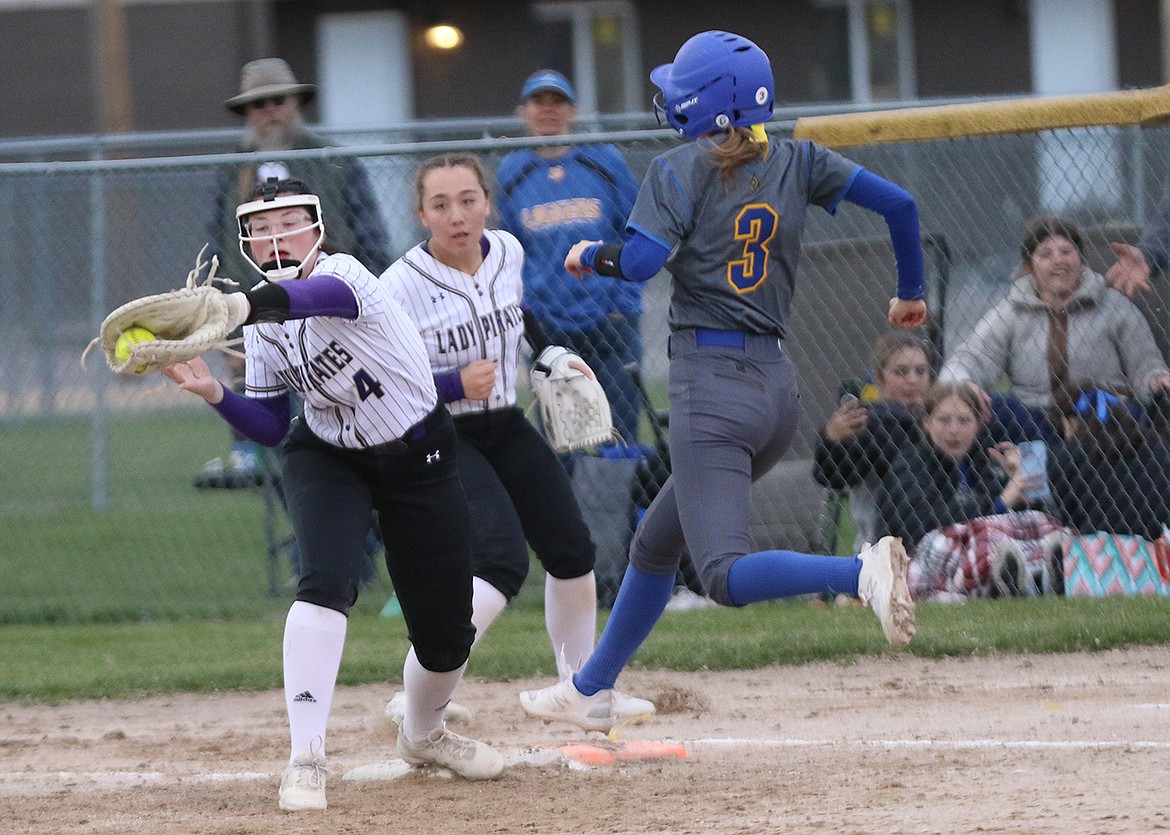 CLOSE CALL: Kailey Smith of Polson makes valiant effort to stop Libby player during last week's matchup, which landed in Polson's win column. (Bob Gunderson photo)