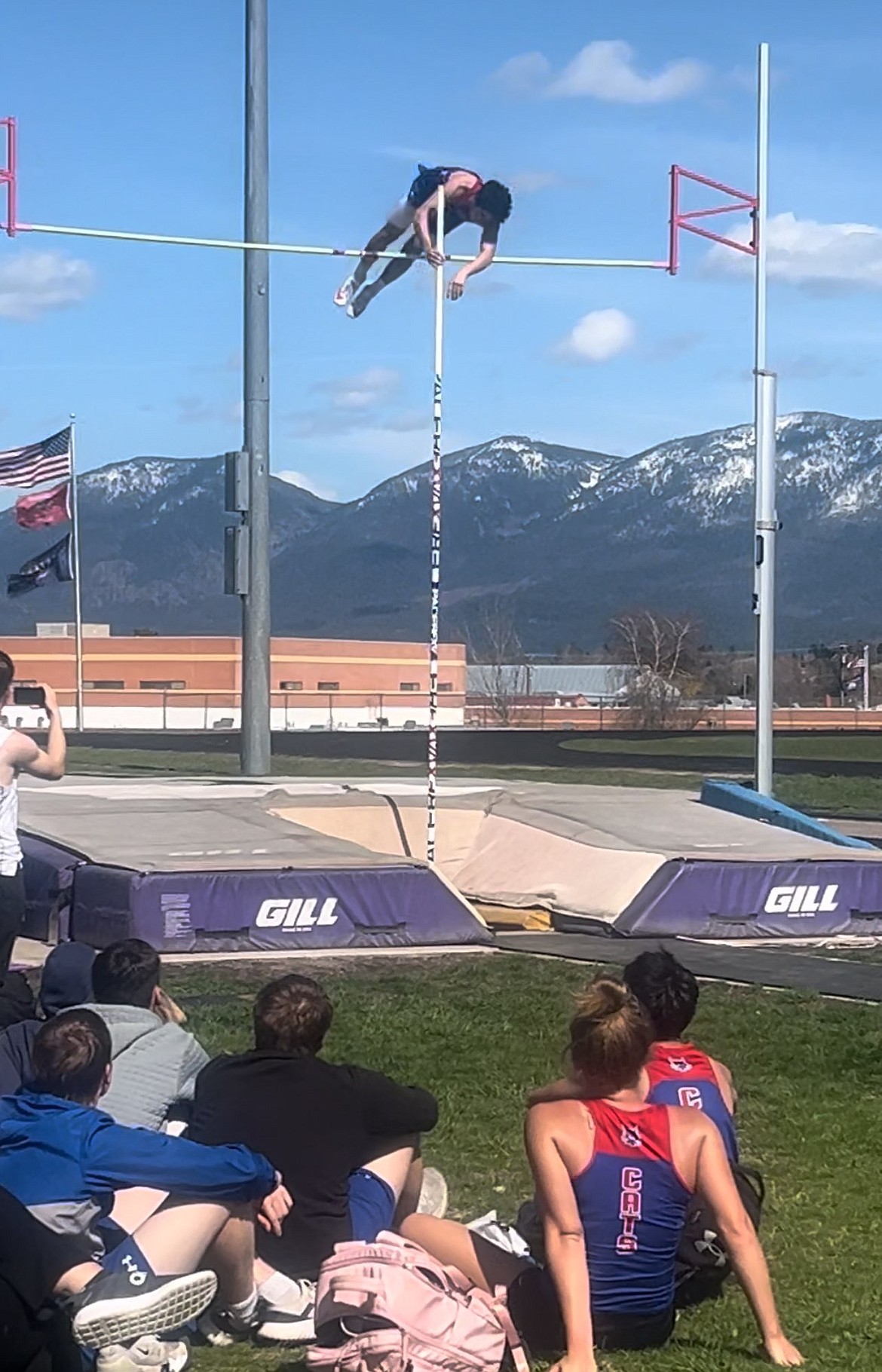 Superior teammates watch as senior Lucas Kovalsky clears 13-6, a new school record and a first place finish in this past weekend's Dave Tripp Invitational in Polson. (Photo by Byron Quinlan)