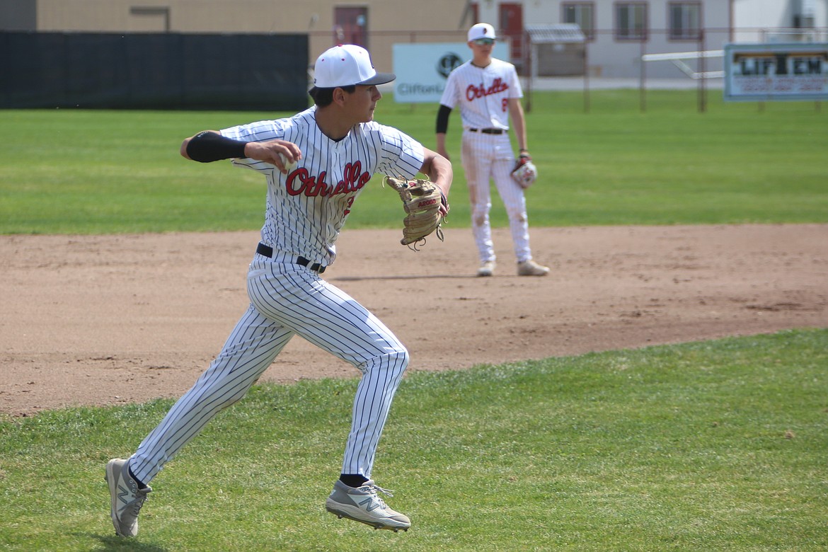 Othello sophomore Trey Tovar III throws the ball back toward first base in the second game of Othello’s doubleheader against Prosser.