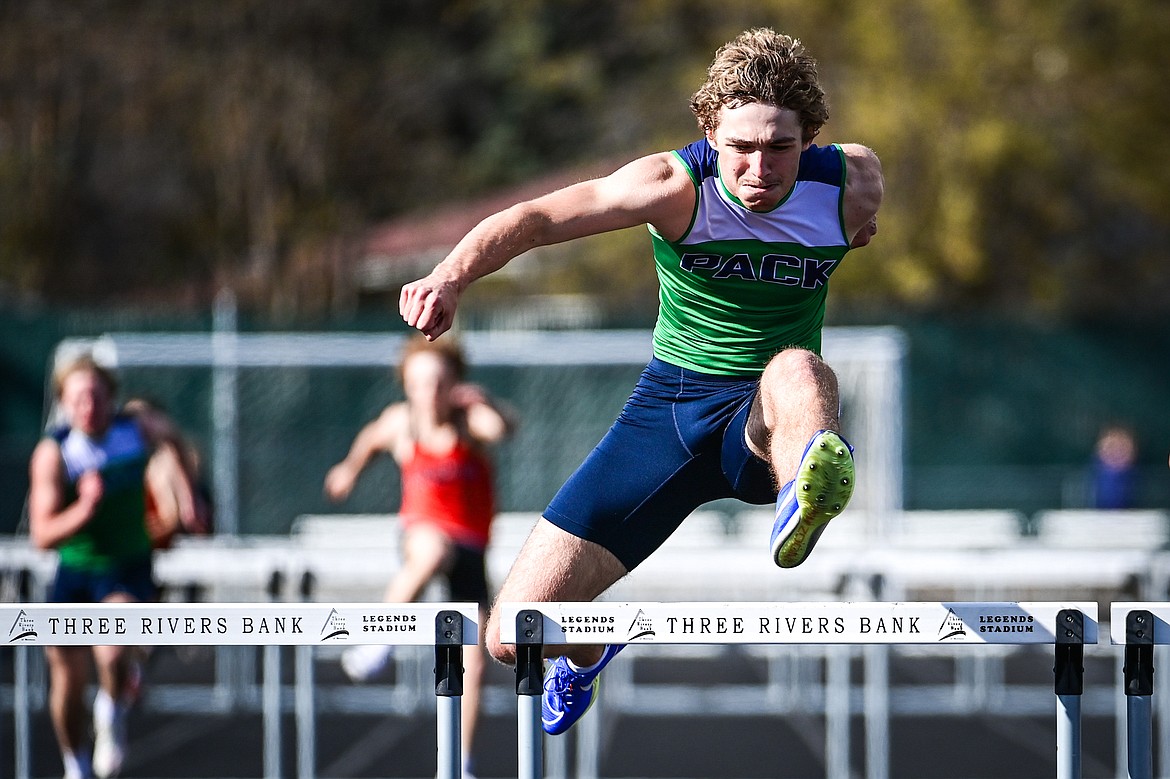 Glacier's Ethan Anderson clears the final hurdle in the boys 300 meter hurdles at Legends Stadium on Tuesday, April 16. (Casey Kreider/Daily Inter Lake)