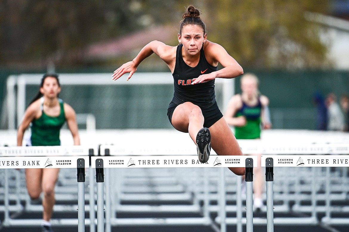 Flathead's Bristol Lenz clears the final hurdle in her first-place finish in the girls 100 meter hurdles at Legends Stadium on Tuesday, April 16. (Casey Kreider/Daily Inter Lake)