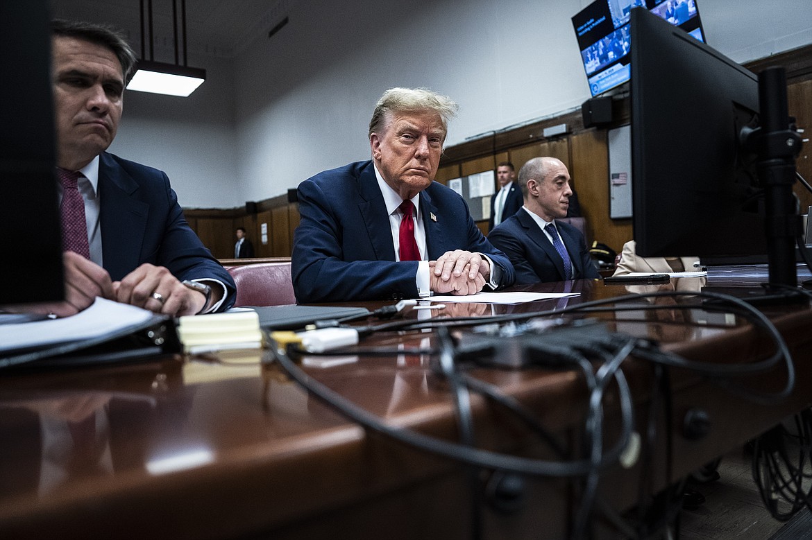 Former President Donald Trump sits in Manhattan criminal court with his legal team in New York, April 15, 2024. A new AP-NORC Center for Public Affairs Research poll found that only about one-third of U.S. adults think Trump did something illegal in the hush money case for which jury selection began Monday, while close to half think he did something illegal in the other three criminal cases pending against him. Still, about half of Americans would consider Trump unfit to serve as president if he is convicted. (Jabin Botsford/Pool Photo via AP)