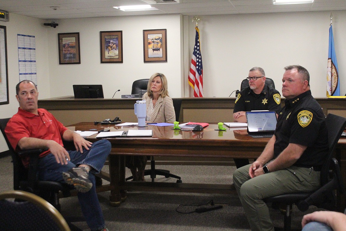 From left, project manager Marc Seeberger, Grant County Commissioner Cindy Carter, Phil Coats, chief corrections deputy for the Grant County Sheriff’s Office, and Grant County Sheriff Joe Kriete consider the options for jail financing at a meeting April 9.