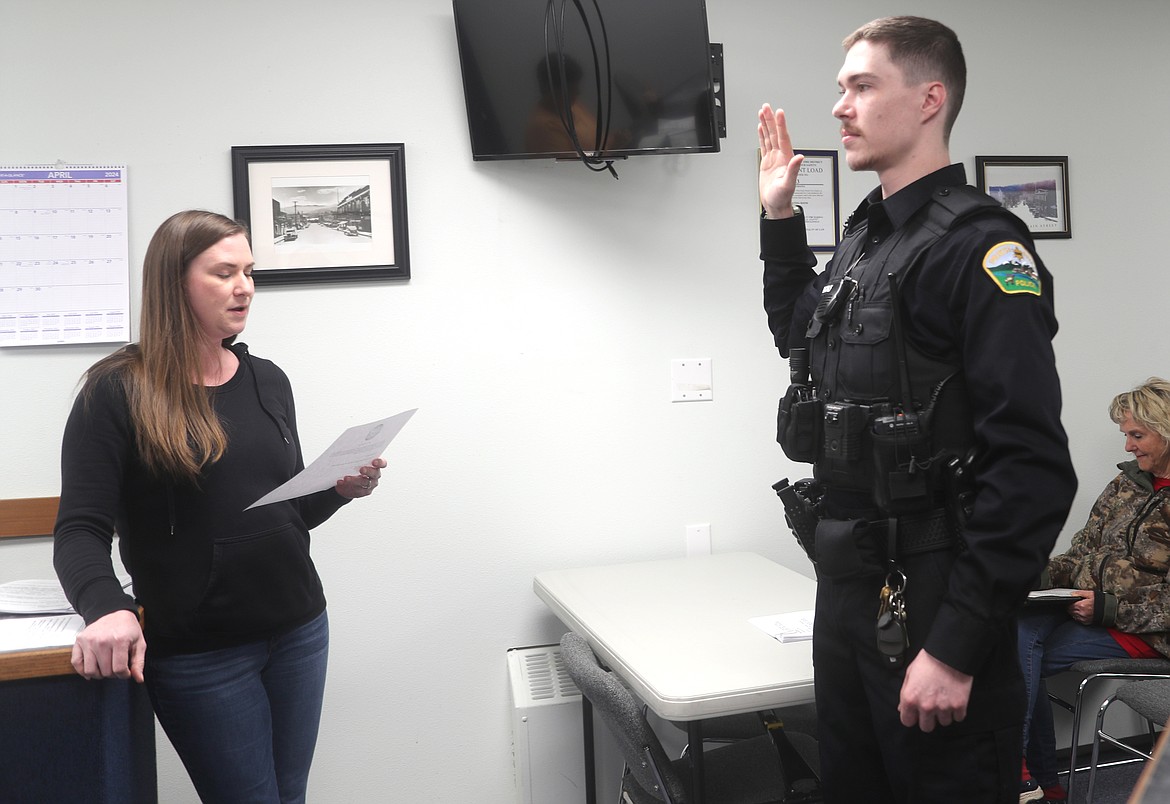 Parker MacAlevy, right, is sworn as Priest River's newest police office by city Clerk Laurel Thomas at the start of Monday's Priest River City Council meeting.