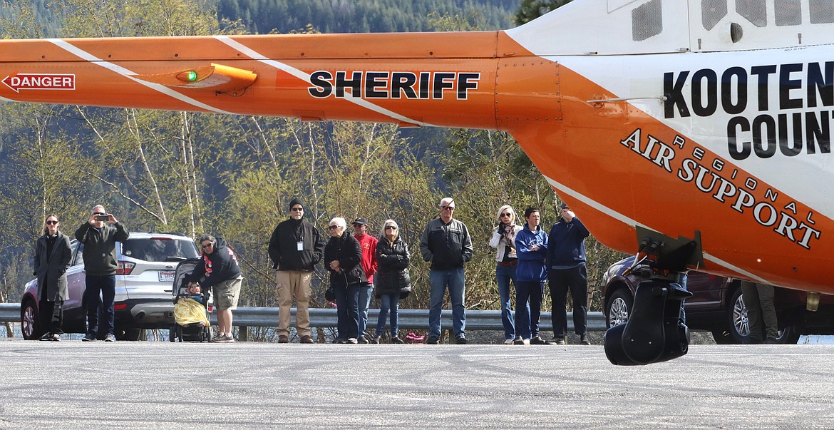 People watch as Kootenai County Sheriff's Office helicopter ABLE1 lands at Higgens Point on Tuesday.