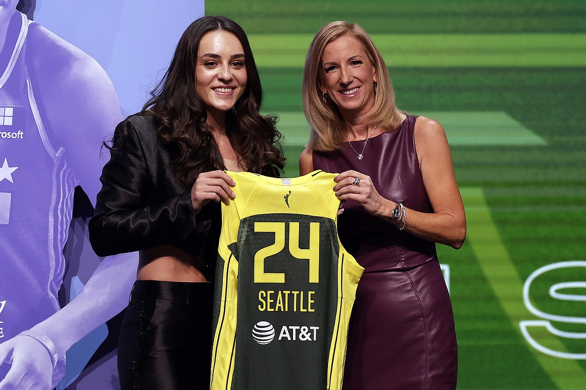 The Seattle Storm spent their second-round pick on UConn’s Nika Muhl, left. Seattle also drafted former Indiana Hoosier Mackenzie Holmes, not pictured, in the second round. WNBA Commissioner Cathy Engelbert is pictured presenting Muhl with a Storm jersey.