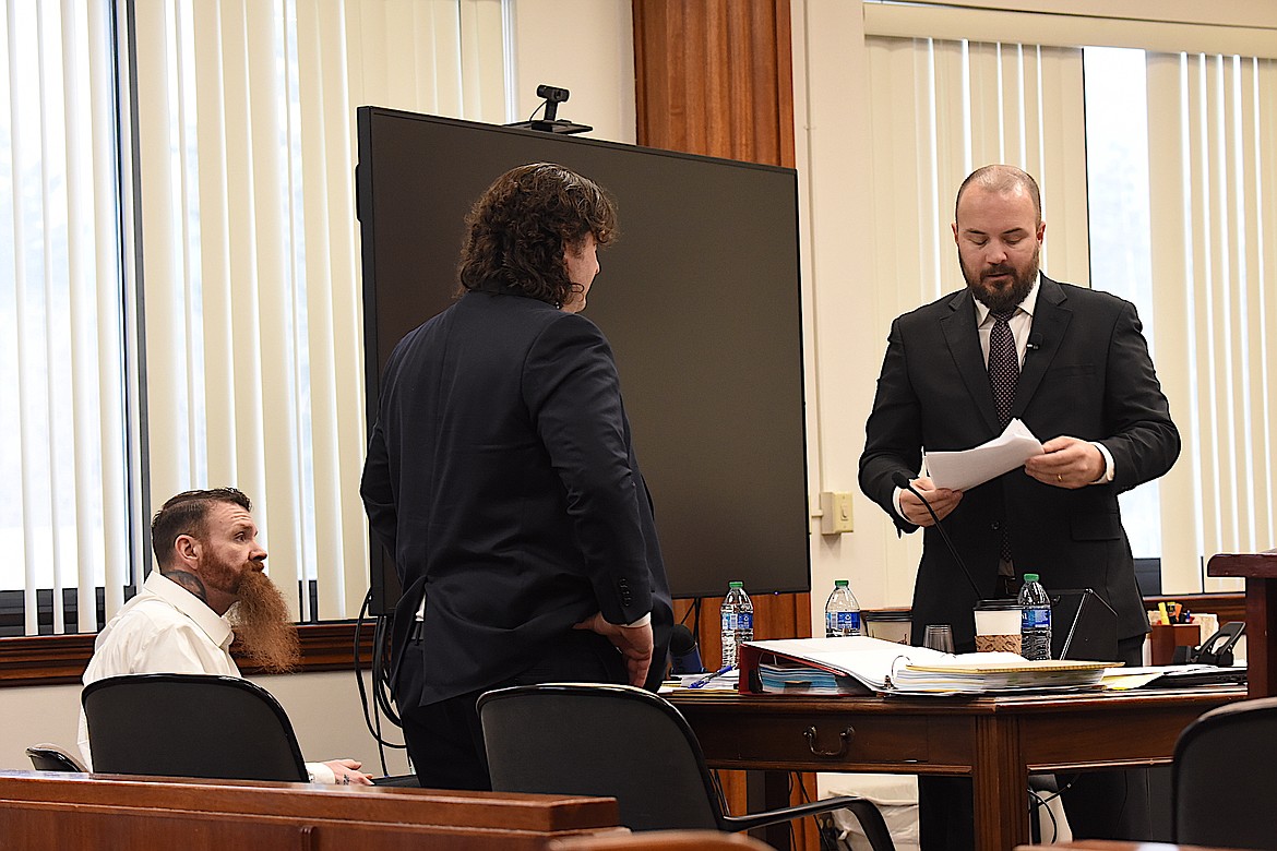 Jason Miller sits at the defense table while his attorneys, Ryan Hennen (center) and Daniel Wood confer during a break Wednesday, April 17, 2024, in the Lincoln County Courthouse. Miller is on trial for attempted deliberate homicide for his alleged involvement in running over Montana Highway Patrol Trooper Lewis Johnson on Feb. 16, 2023, near Koocanusa Dam. (Scott Shindledecker/The Western News)