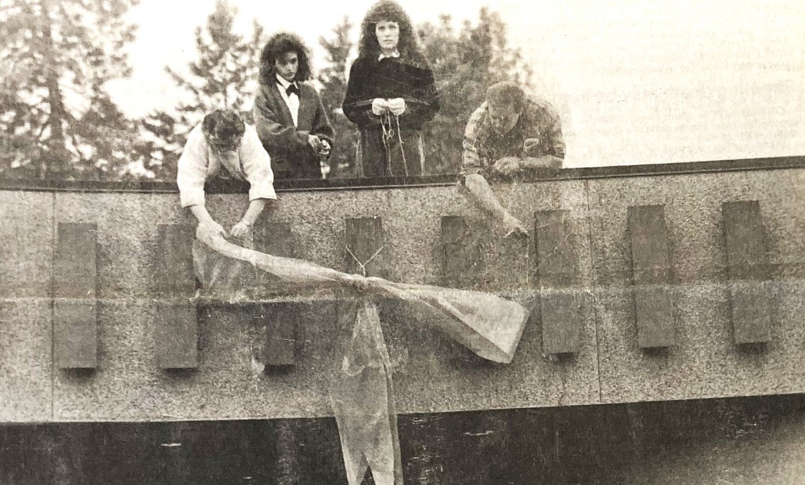 These North Idaho College students tie an orange ribbon on the student union building to protest the skinhead convention. From left, Pat Kraut, Elaine Wilches-Pena, ASB President Mary Jo Hansen and Doug Hayman.