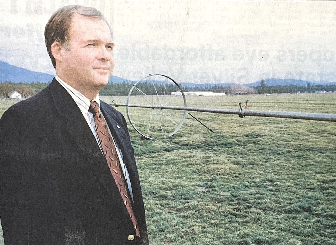 Real estate broker Gary Schneidmiller stands in a grass field that became Coeur d’Alene Place.