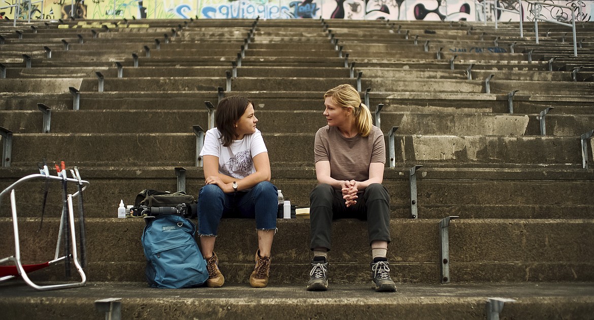 This image released by A24 shows Cailee Spaeny, left, and Kirsten Dunst in a scene from "Civil War."