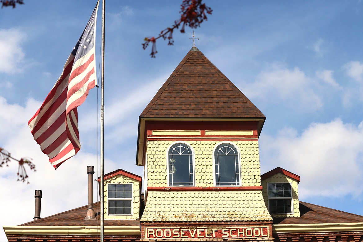 The American flag flies in front of the old Roosevelt School on Wednesday.