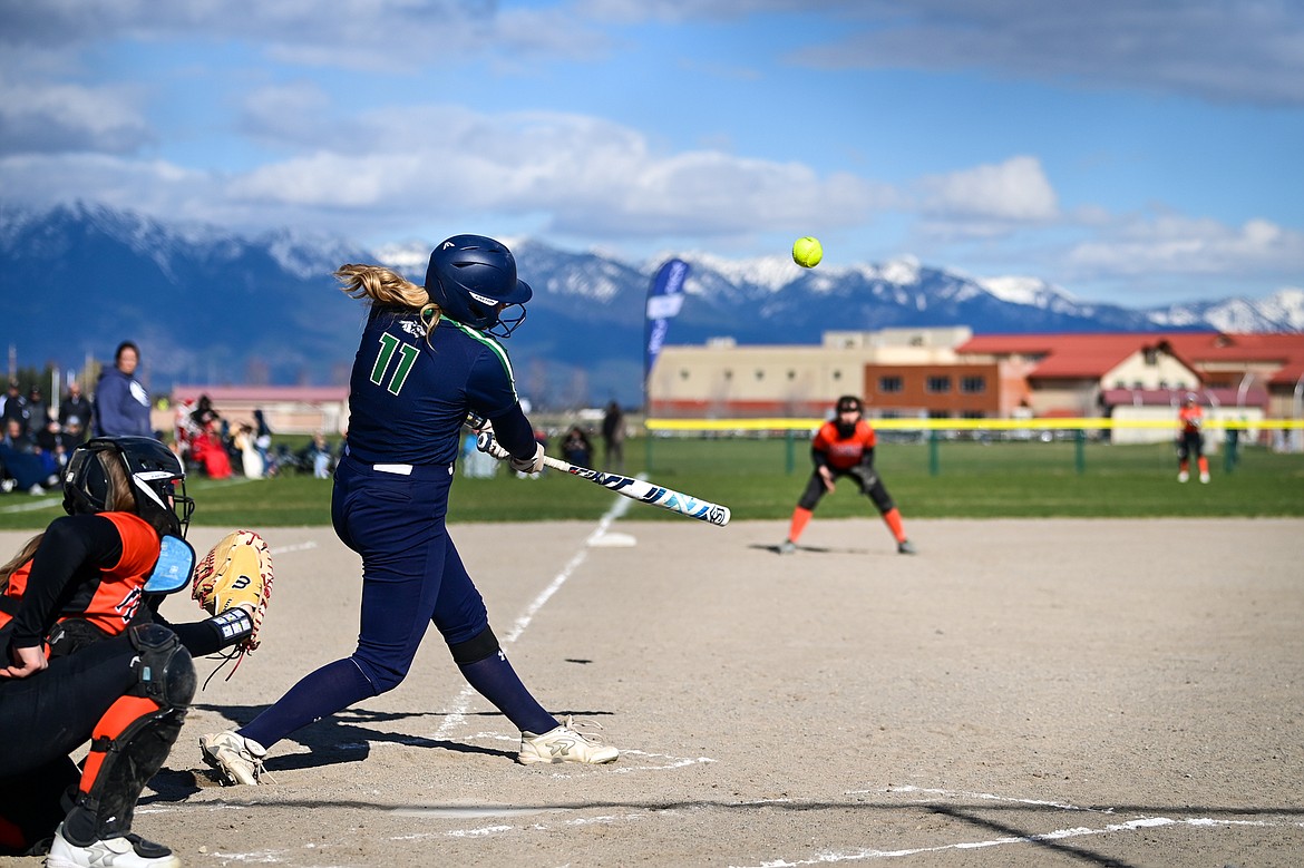 Glacier's Emma Cooke (11) connects on a two-run home run in the first inning against Flathead at Glacier High School on Thursday, April 18. (Casey Kreider/Daily Inter Lake)