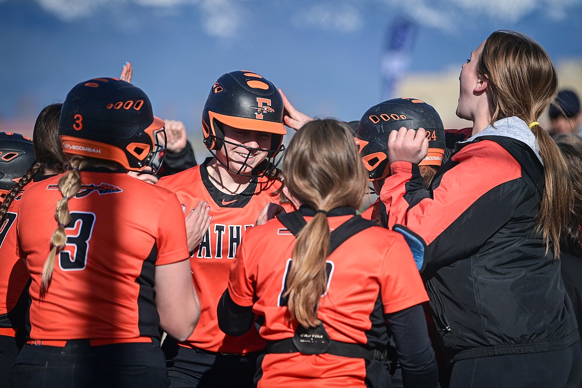 Flathead's Kaidyn Lake (10) flashes a smile as she's congratulated by teammates after her two-run home run in the fourth inning against Glacier at Glacier High School on Thursday, April 18. (Casey Kreider/Daily Inter Lake)
