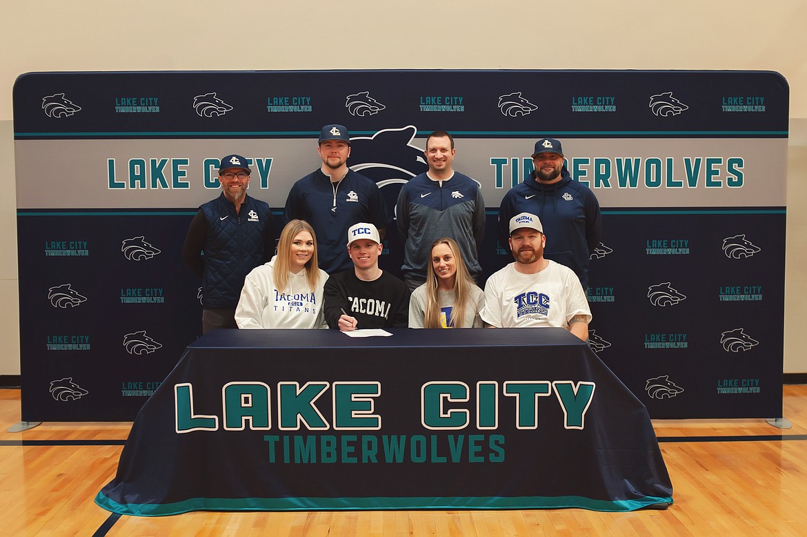 Courtesy photo
Lake City High senior Chris Reynolds recently signed a letter of intent to play baseball at Tacoma Community College. Seated from left are Chelsea Reynolds (sister), Chris Reynolds, Hannah Reynolds (stepmother) and Scott Reynolds (father); and standing from left, Mike Criswell, Lake City High head baseball coach; Cody Garza, Lake City High assistant baseball coach; Troy Anderson, Lake City High athletic director; and Justin Garza, Lake City High assistant baseball coach.