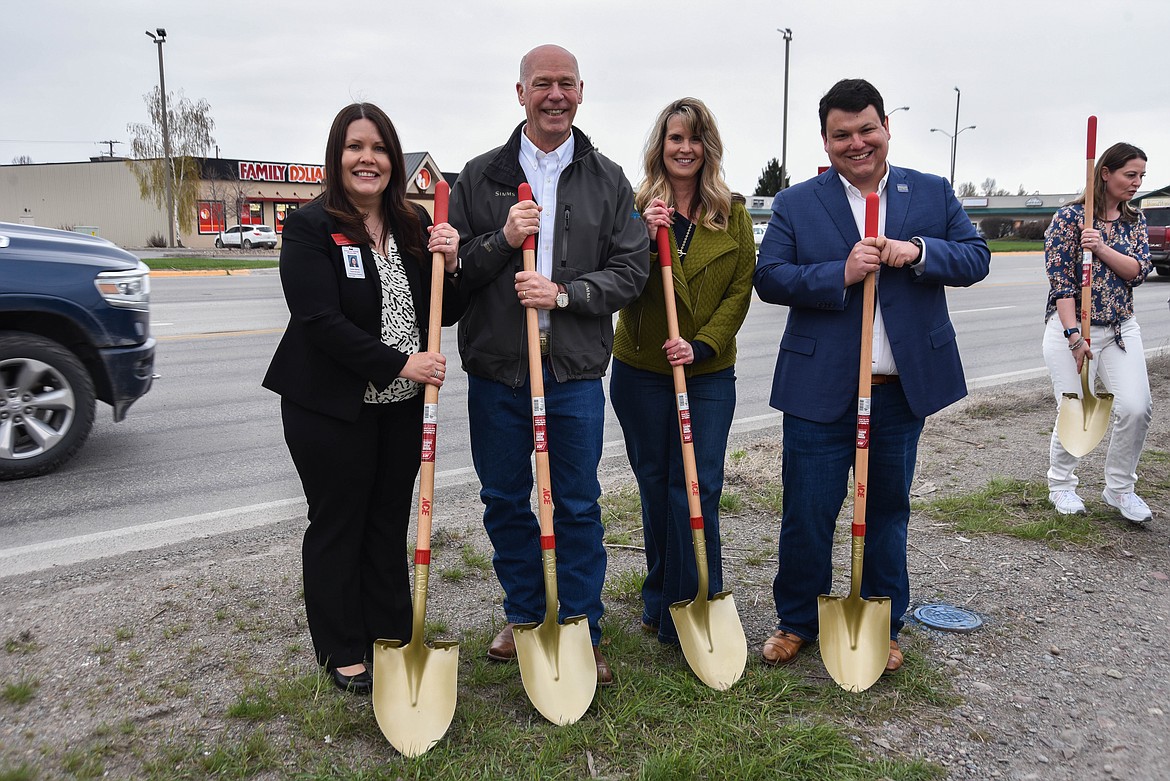 Evergreen School District superintendent Laurie Barron, Gov. Greg Gianforte, Evergreen Community Partners president Darla Harmon and Rep. Tony Brockman hold shovels to break ground on the long-awaited Evergreen sidewalk project. (Kate Heston/Daily Inter Lake)