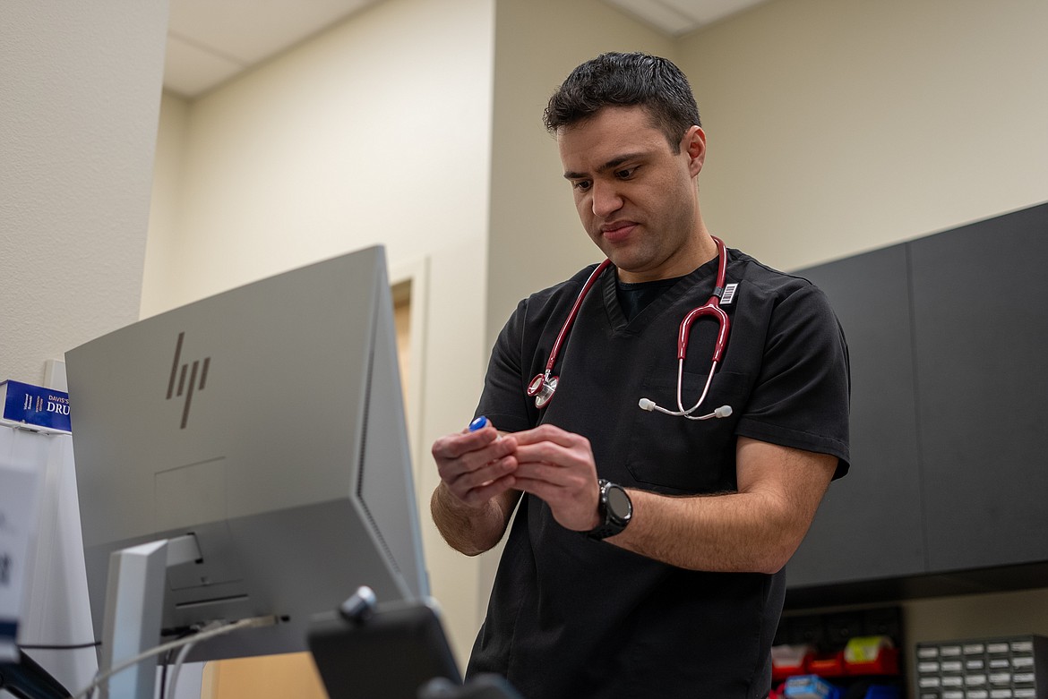 Daniel Guerrero inspects a medicine label in a nursing lab in the Meyer Health and Sciences Building at NIC’s Coeur d’Alene campus.