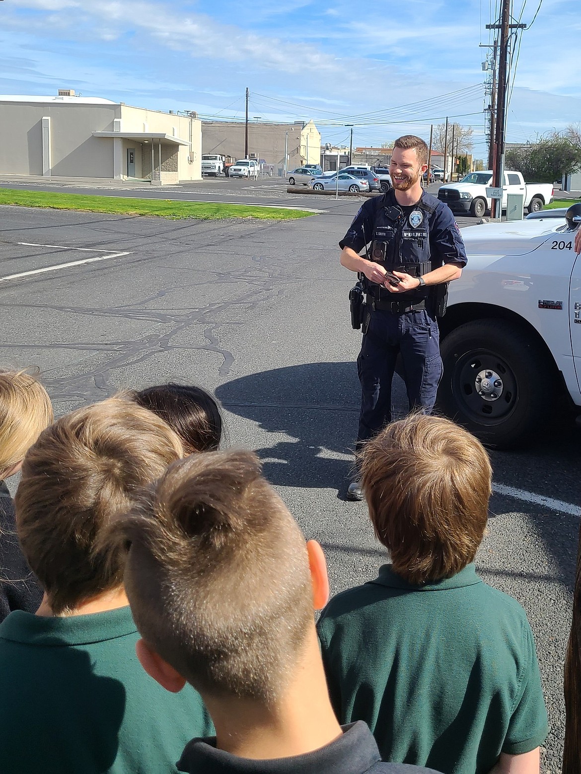 Ephrata Police Officer Zachary Smith talks with second-graders from New Life Christian School last week.