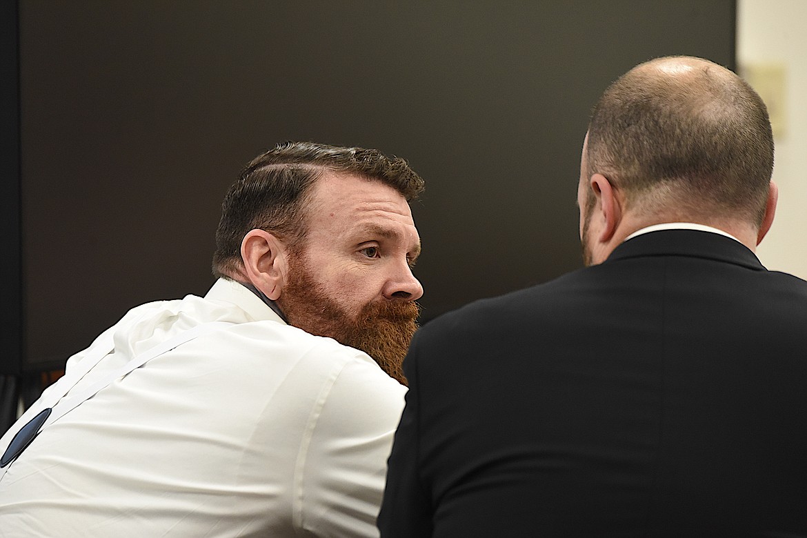 Jason Miller, left, speaks with defense attorney Daniel Wood during his trial in Lincoln County District Court on Friday, April 19. (Scott Shindledecker/The Western News)