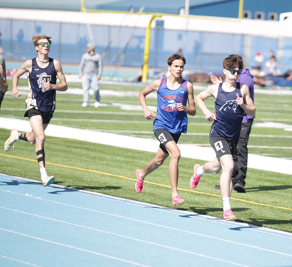 JASON ELLIOTT/Press
Coeur d’Alene Charter senior Nathan Russell keeps a few steps ahead of Coeur d’Alene’s Gabriel Heule and Timberlake’s Jacob Barnhart during the second lap of the boys 1,600-meter run at the Rasmussen Invitational on Friday at Coeur d’Alene High.