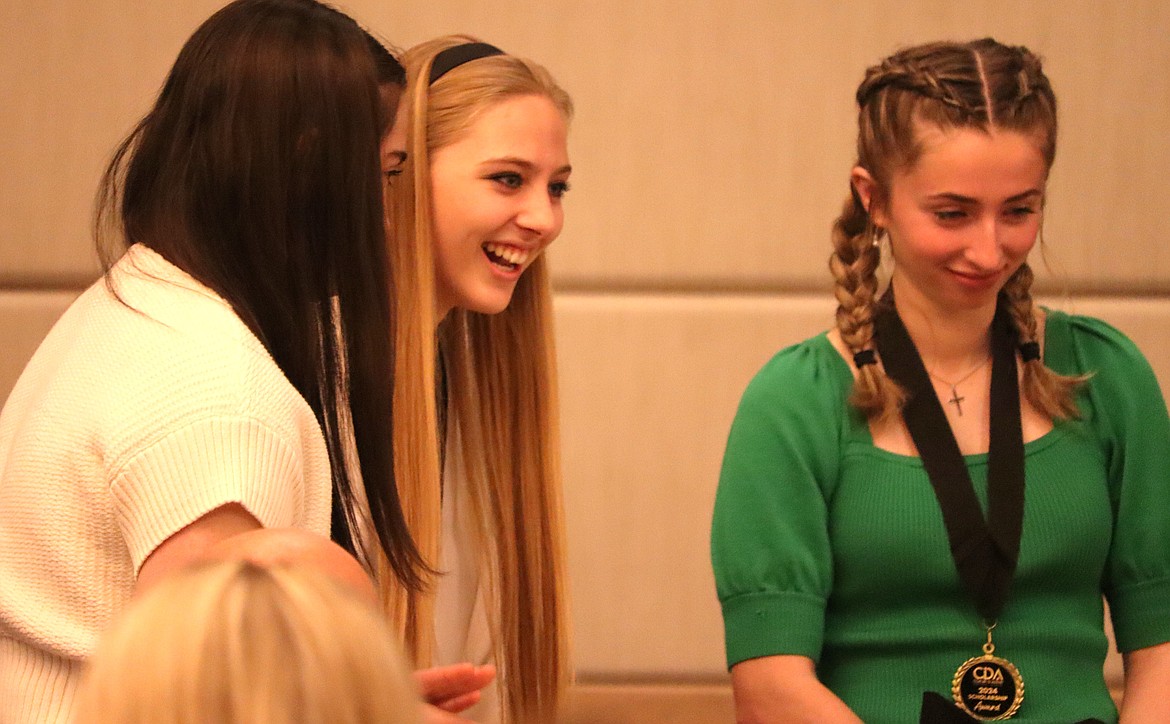 Peyton Duffield of Coeur d'Alene Charter Academy, center, laughs during Friday's annual student scholarship breakfast at The Coeur d’Alene Resort.