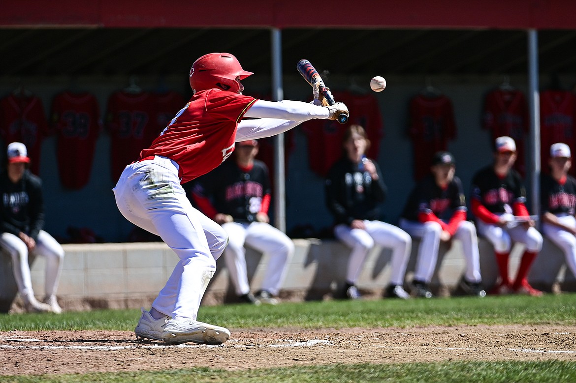 Lakers AA's Bryce Buckmaster (17) bunts in a run from third on safety squeeze in the fourth inning against the Cranbrook Bandits at Griffin Field on Saturday, April 20. (Casey Kreider/Daily Inter Lake)