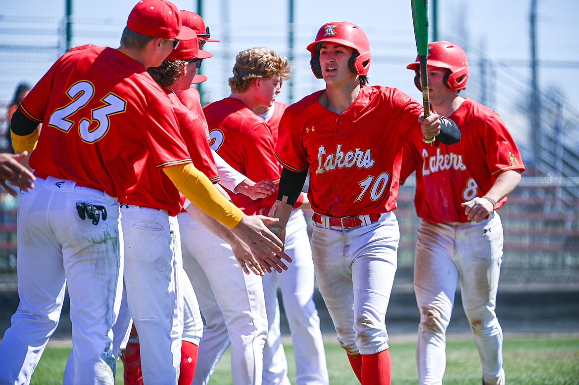 The Lakers AA congratulate Ostyn Brennan (10) and Michael Owens (8) after scoring on Kaden Drish's two-run single in the third inning against the Cranbrook Bandits at Griffin Field on Saturday, April 20. (Casey Kreider/Daily Inter Lake)