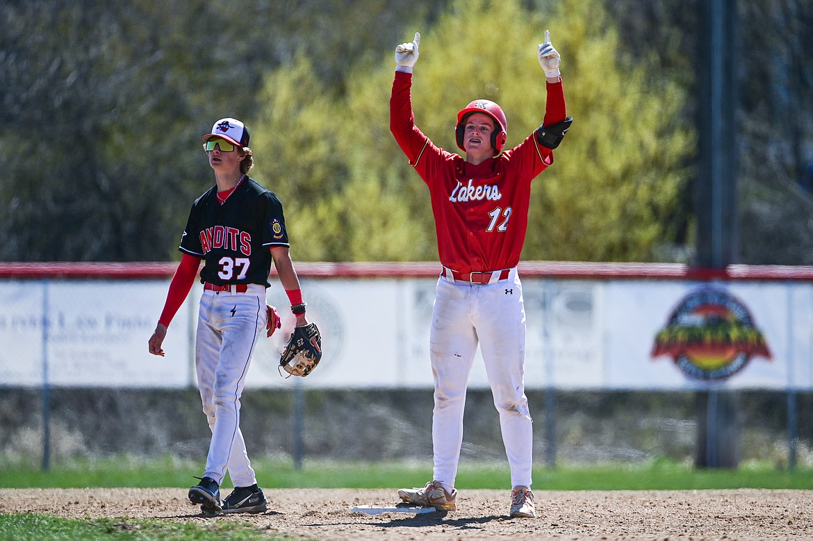Lakers AA's Luke Nikunen (12) celebrates with the dugout after hitting a double against the Cranbrook Bandits at Griffin Field on Saturday, April 20. (Casey Kreider/Daily Inter Lake)