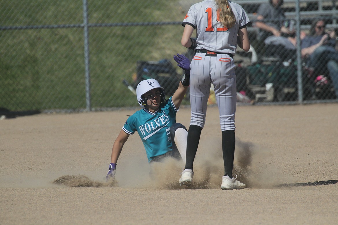 MARK NELKE/Press
Sammie Chavez (5) of Lake City slides into second base as Jaya Felix (19) of Post Falls awaits the throw on Saturday at Lake City High.