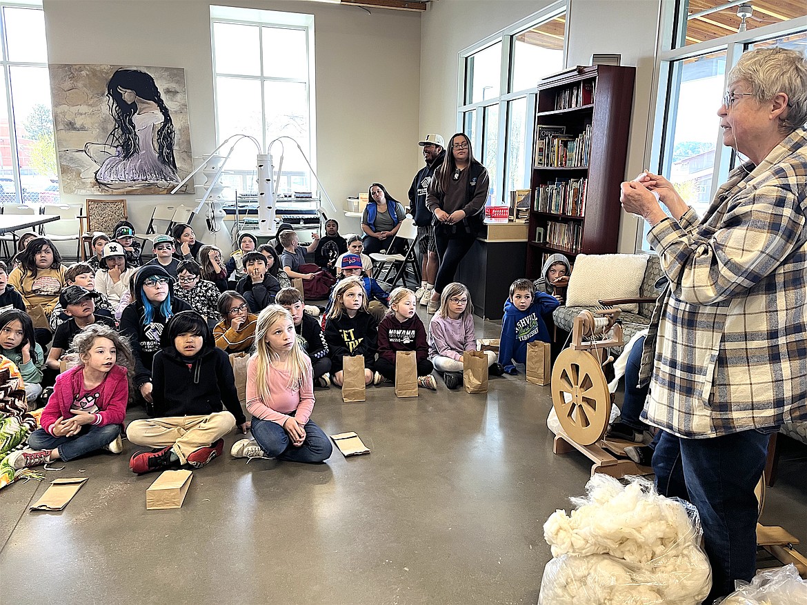 Linda Kittle demonstrated the steps that spinners take to transform raw wool into yarn at the Boys and Girls Club in Polson last week, with help from fellow spinners Mary Hertz and Mary Sale. (Kristi Niemeyer/Leader)