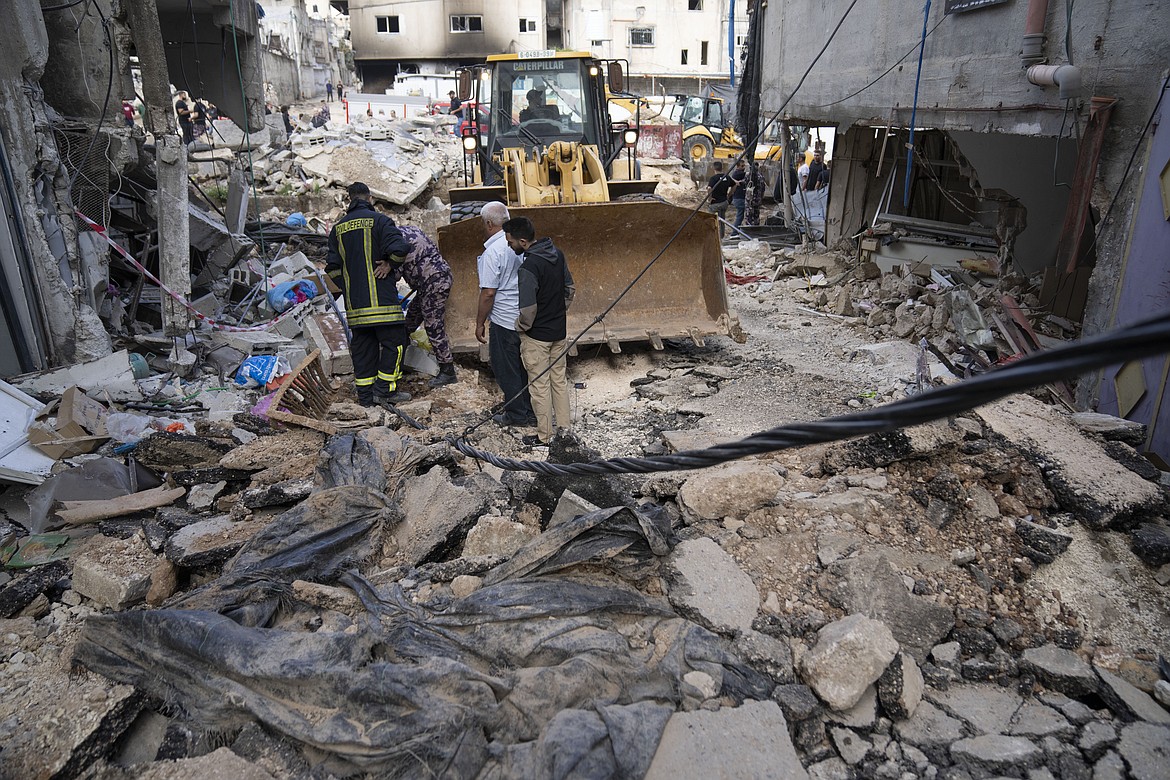 Palestinian municipality workers clear the rubble in the West Bank refugee camp of Nur Shams, Tulkarem, Sunday, April 21, 2024. The Palestinian Red Crescent rescue service meanwhile said it has recovered more than a dozen of bodies from an Israeli raid in the Nur Shams urban refugee camp in the West Bank that began late Thursday. Those killed include three militants from the Islamic Jihad group and a 15-year-old boy. (AP Photo/Nasser Nasser)