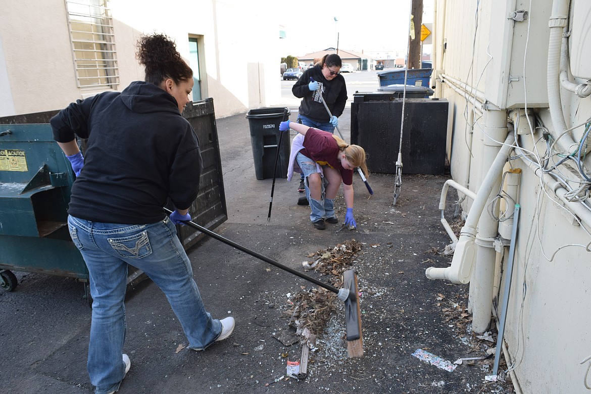 Rosenda Henley (foreground) sweeps an alley in downtown Moses Lake with Tiffany Shipman and her mother Jennifer Shipman at last year’s Downtown Moses Lake Association Spring Cleanup. This year’s event is Saturday.