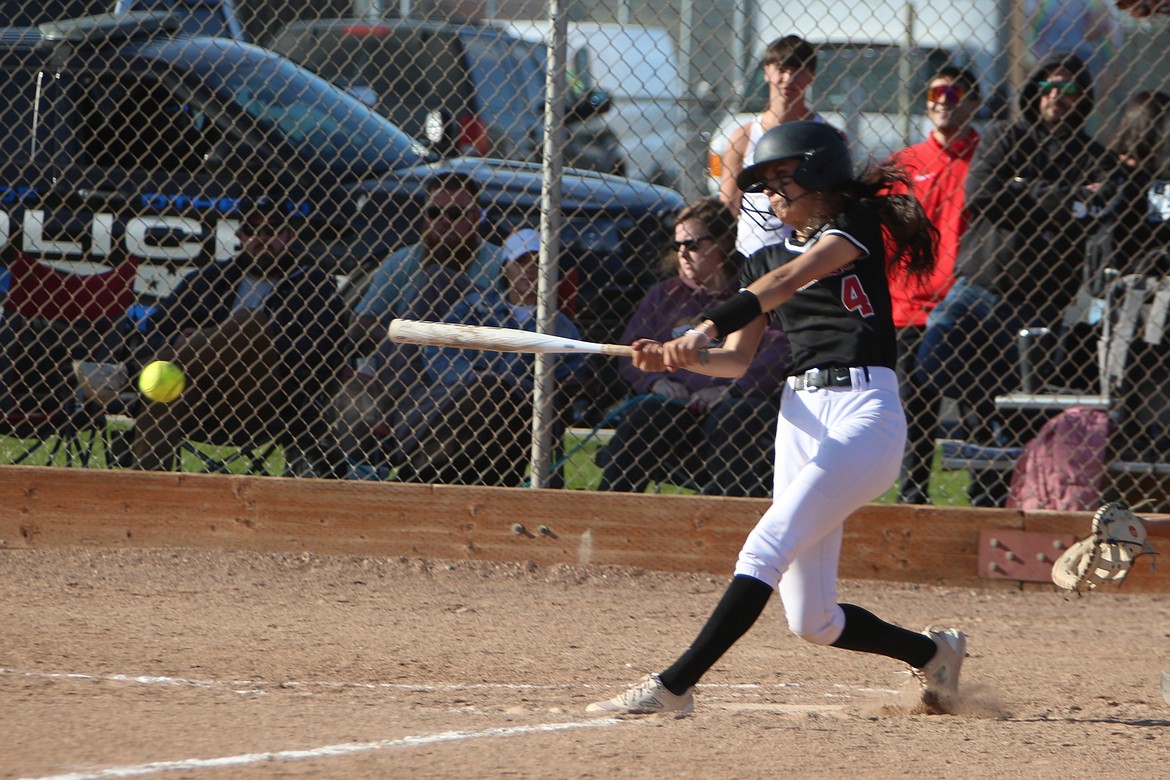 Othello senior Miccaela Valdez (4) delivers a hit in the second game of the Huskies’ doubleheader against Prosser on Friday.