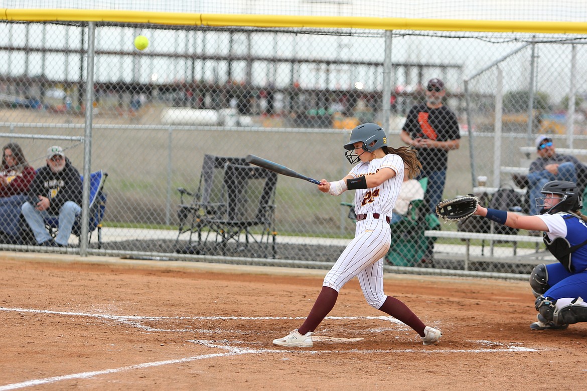 Moses Lake senior Lexi Cox, in white, hits the ball during a game against Walla Walla on April 12.