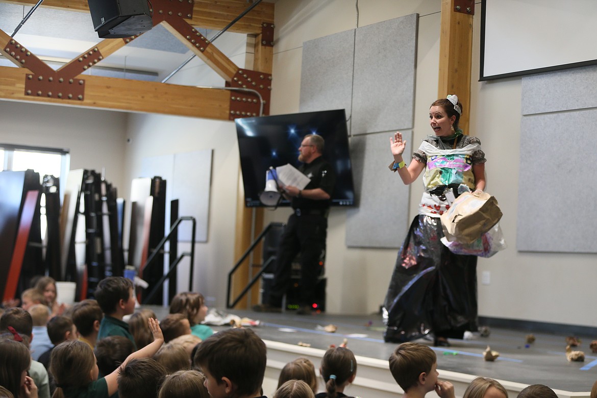 Second-grade teacher Nicki Osborne gives a queenly wave Monday during Hayden Canyon Charter's new upcycled styles event, the Trashin' Fashion Show.